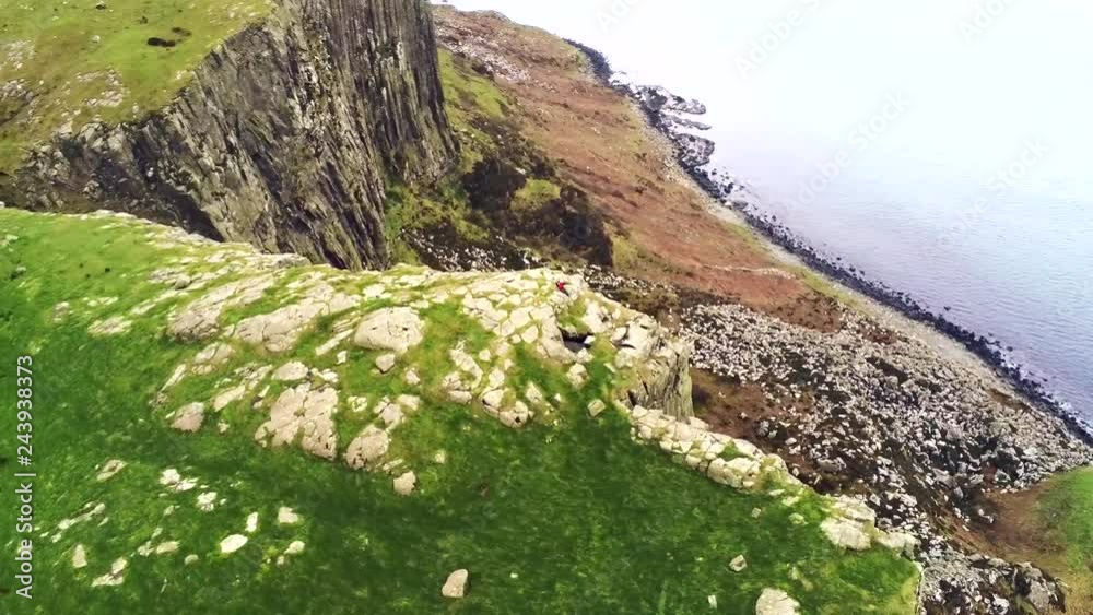 Hiker on the Edge of a Sea Cliff Hiker on the Edge of a Sea Cliff