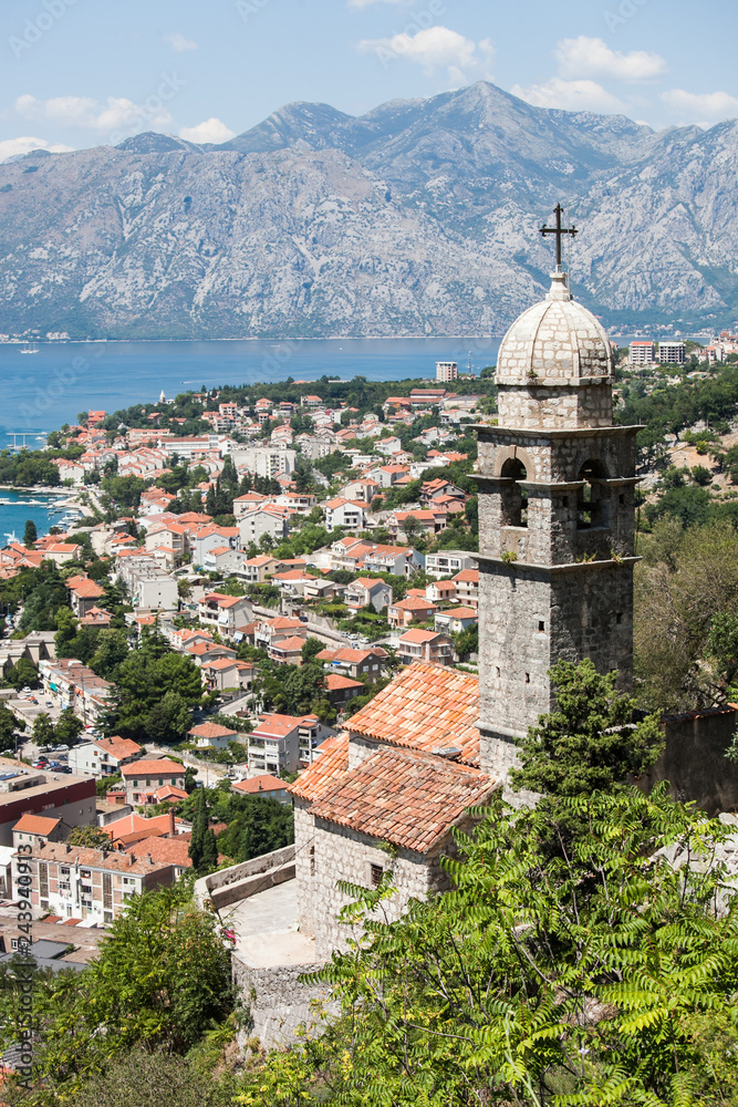 Scenic view of the historic Old Town of Kotor, Kotor Bay with an old Church of Our Lady of Remed with a bell tower in the foreground. Lovcen Mountain, Montenegro, Balkans