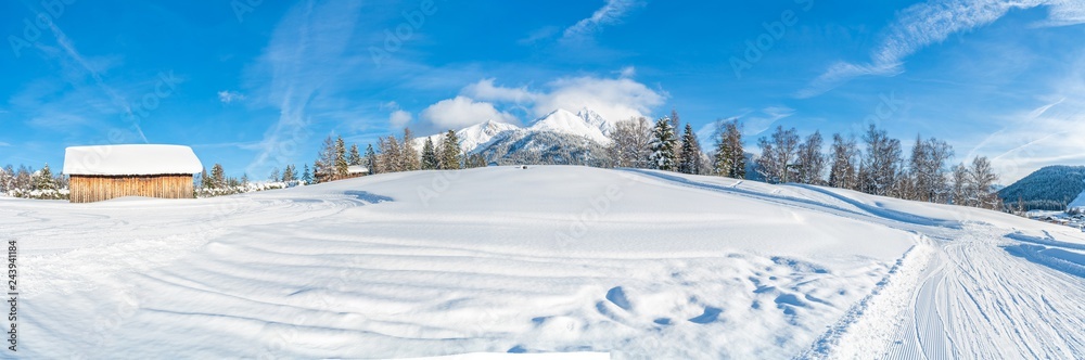 Wide panoramic view of winter landscape with snow covered trees and Alps in Seefeld in the Austrian state of Tyrol. Winter in Austria Wide panoramic view of winter landscape with snow covered trees and Alps in Seefeld in the Austrian state of Tyrol. Winter in Austria