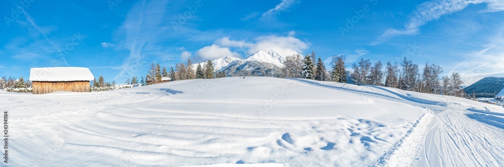 Wide panoramic view of winter landscape with snow covered trees and Alps in Seefeld in the Austrian state of Tyrol. Winter in Austria