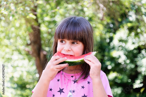 healthy eating concept, girl eats watermelon outdoors