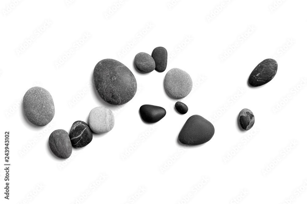 Scattered sea pebbles. Smooth gray and black stones isolated on white background. Top view Scattered sea pebbles. Smooth gray and black stones isolated on white background. Top view