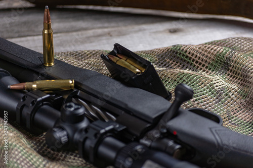 Rifle bolt action sniper weapon gun and ammo isolated on multicam background