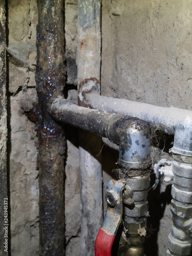 closeup of old dirty rusty metallic pipeline in bathroom need to be replaced