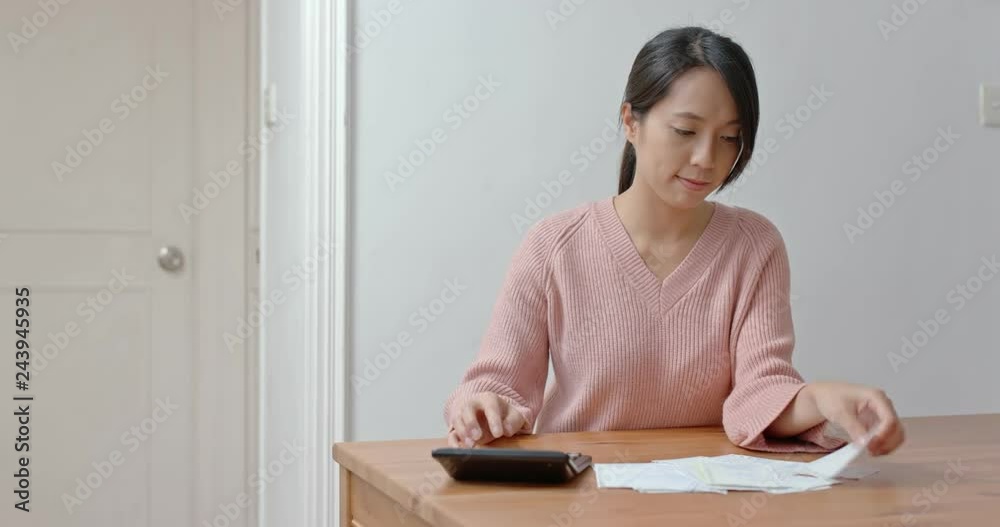 Woman calculate the expenditure for daily use Woman calculate the expenditure for daily use