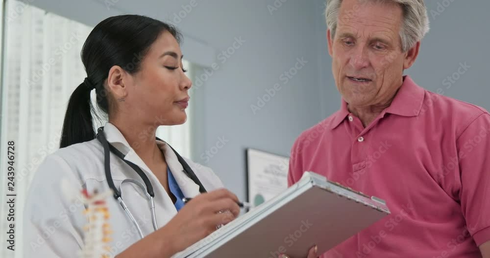 Female primary care physician taking medical history from aging patient Female primary care physician taking medical history from aging patient