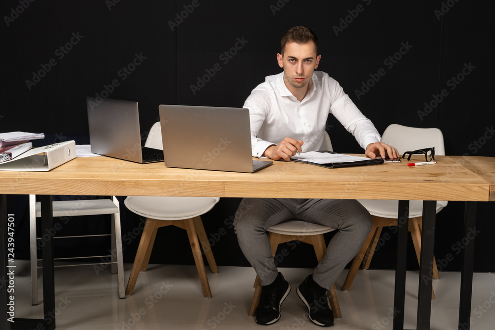 Focused serios businessman thinking of online task