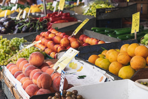 Green olives, peaches, oranges, vegetables and fruits for sale at the Athens Central Market in Greece.