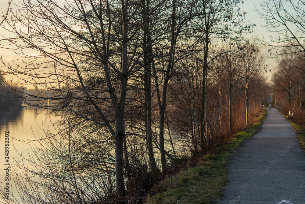 Fussweg neben Fluss bei Sonnenuntergang Fussweg neben Fluss bei Sonnenuntergang