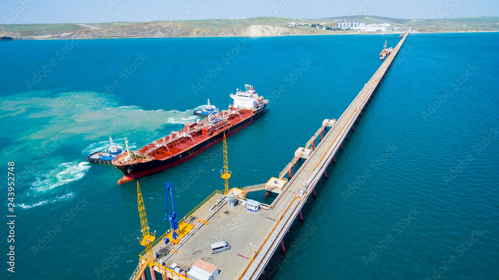 tanker moored to the port using tugs