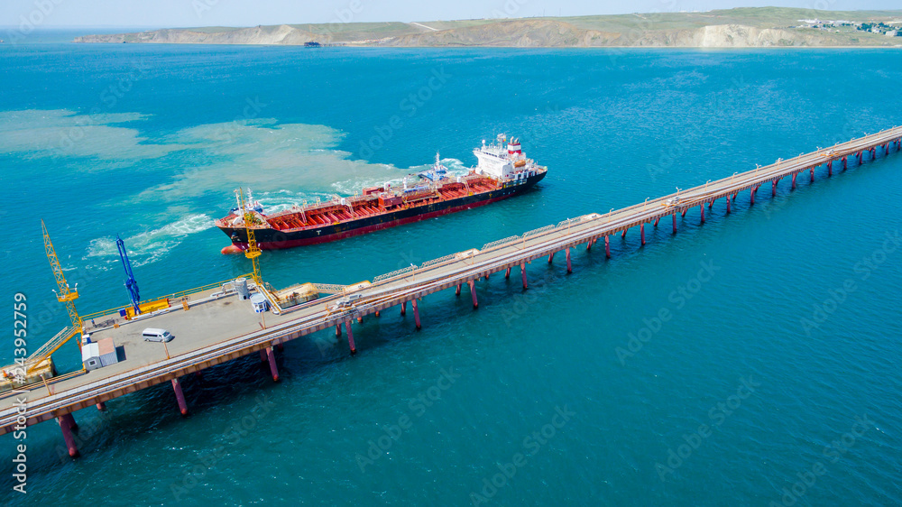 tanker moored to the port using tugs