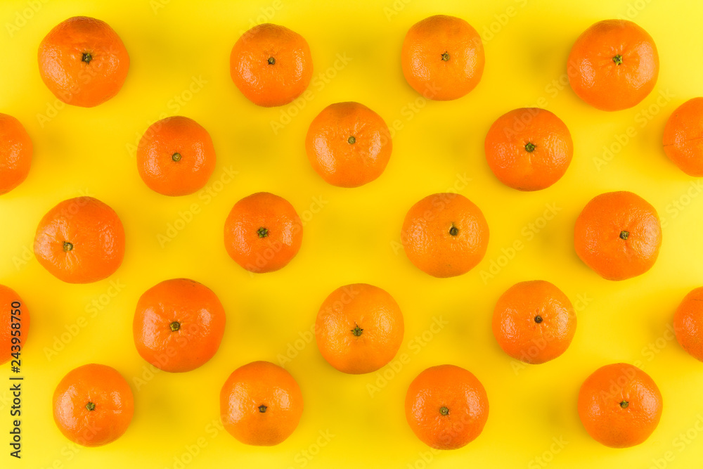 Fruit pattern of mandarin isolated on yellow background. Tangerine. Flat lay, top view. Fruit pattern of mandarin isolated on yellow background. Tangerine. Flat lay, top view.