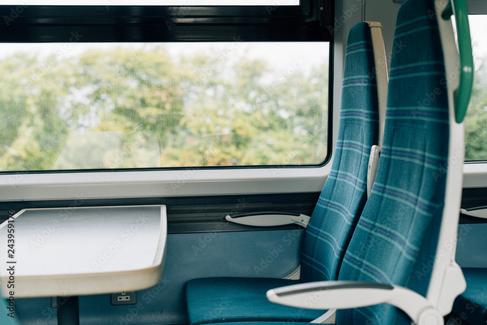 Fototapeta premium Empty seats with a tray on a train