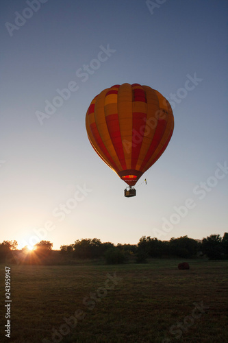 Hot air balloon flying at sunrise