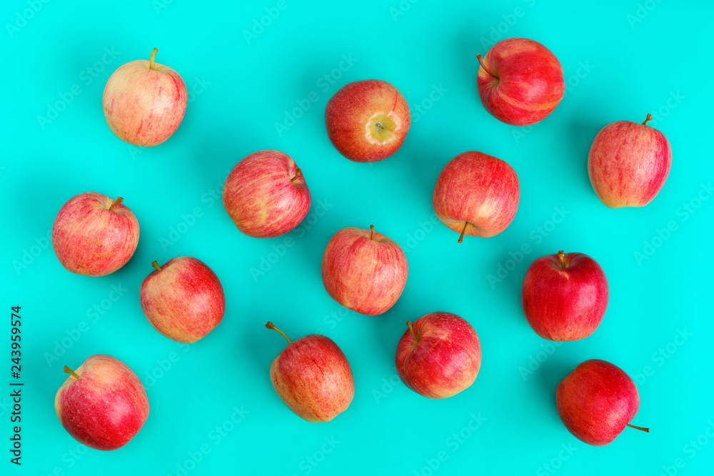 Fruit pattern of red apple on blue background. Flat lay, top view. Pop art design, creative summer concept. Food background. Fruit pattern of red apple on blue background. Flat lay, top view. Pop art design, creative summer concept. Food background.