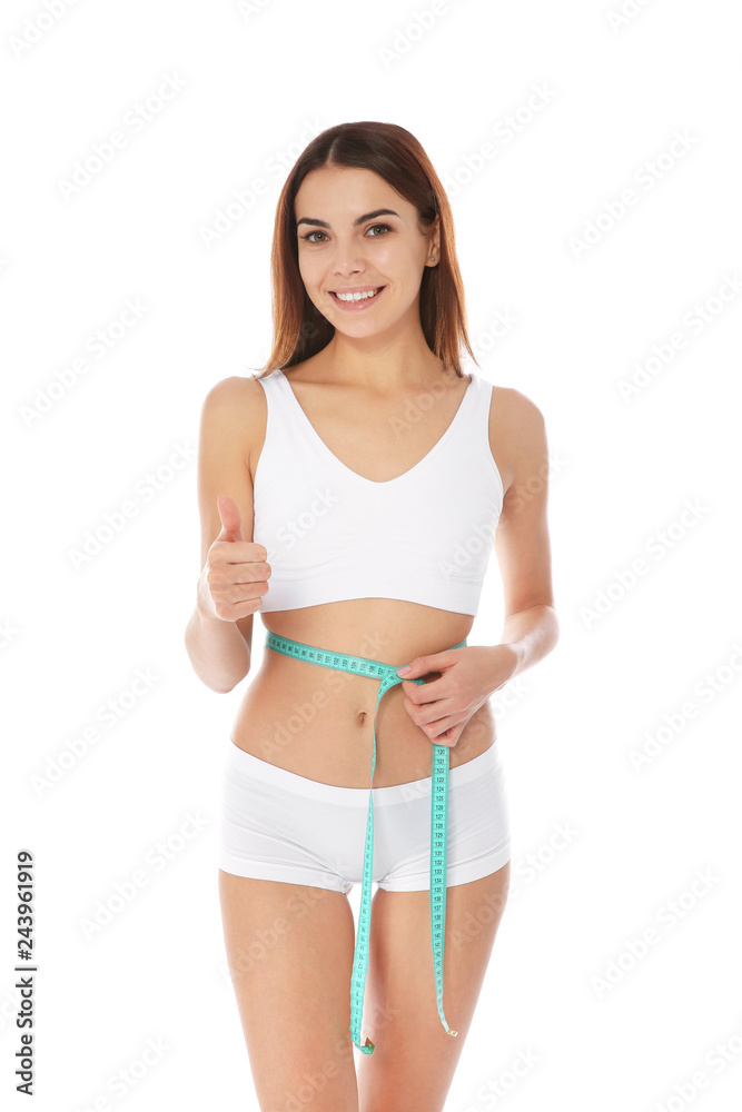 Slim woman measuring her waist on white background. Weight loss Slim woman measuring her waist on white background. Weight loss