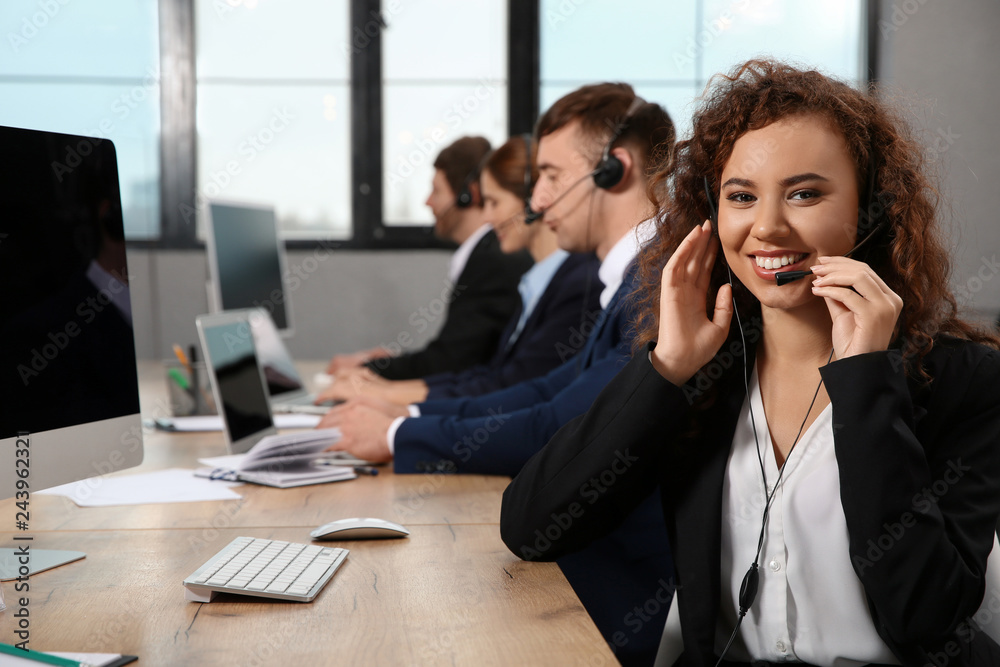 Team of technical support with headsets at workplace Team of technical support with headsets at workplace