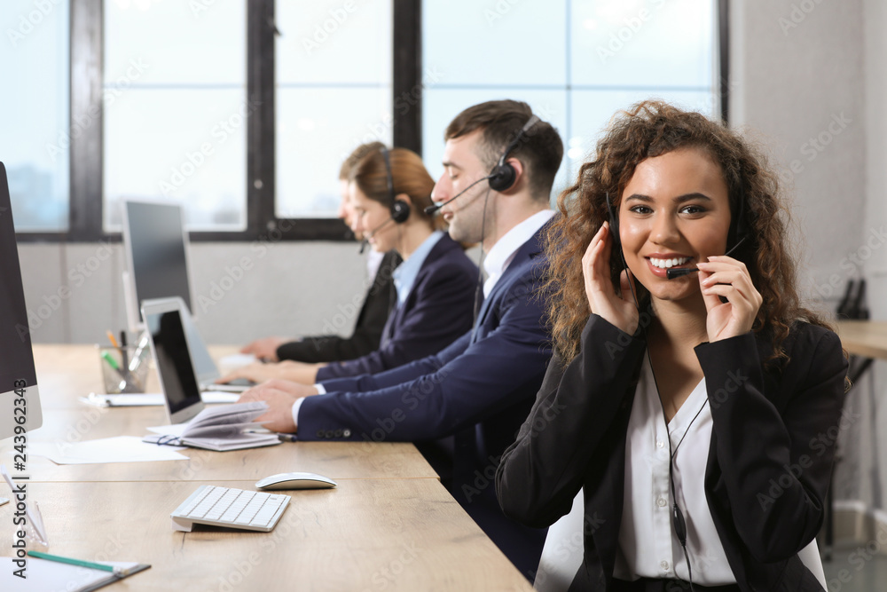 Team of technical support with headsets at workplace Team of technical support with headsets at workplace