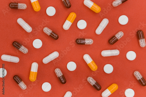 Medical Or Pharmaceutical Preparations: Assorted Colorful Tablets, Pills, Medicines And Capsules On Pale Pastel Orange Background, Top View.