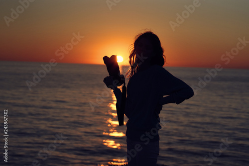 sunset woman with camera silhouette sea