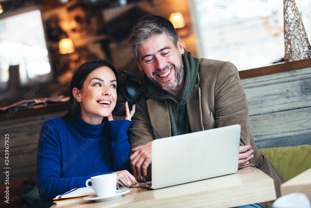 Smiling couple using digital tablet in cafe Smiling couple using digital tablet in cafe