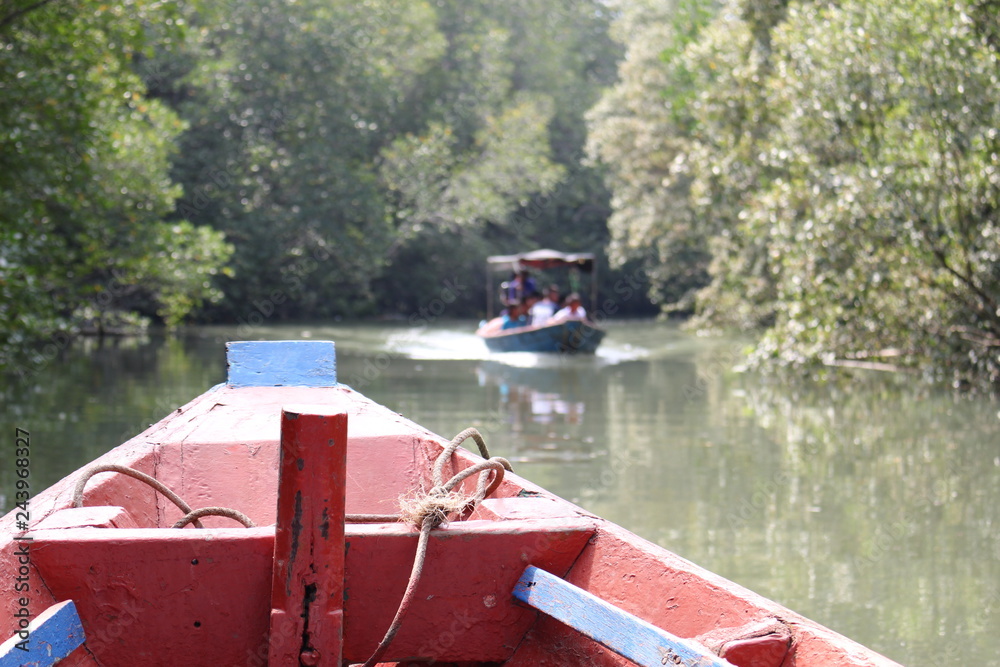 The Bow of an Old Red Wooden Boat on a River. Location is Tung Prong Thong Nature Reserve, Thailand. The Bow of an Old Red Wooden Boat on a River. Location is Tung Prong Thong Nature Reserve, Thailand.