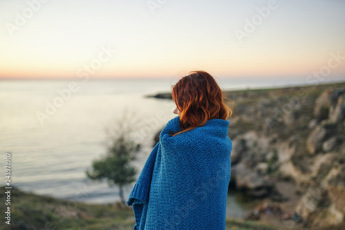 woman in a blanket on the sea evening