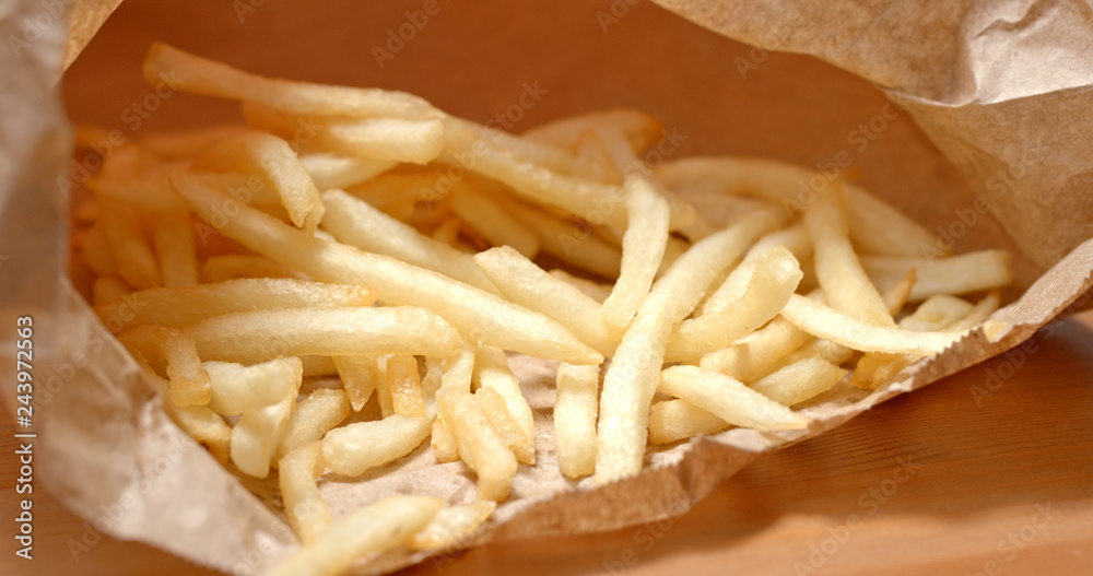 French fries inside paper bag