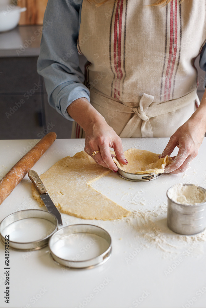 Woman in Apron making tarts Woman in Apron making tarts