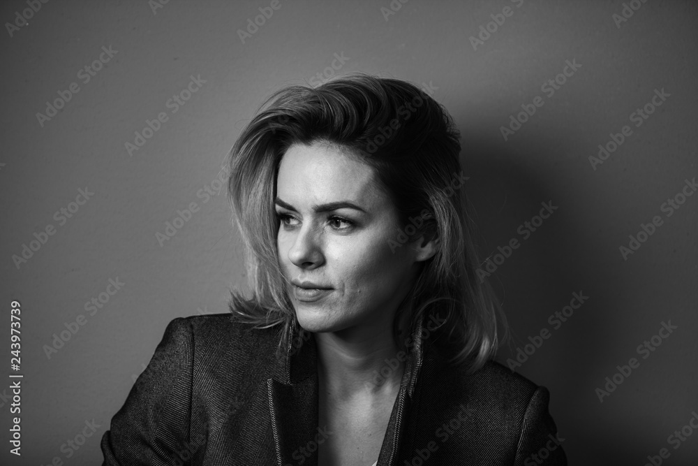 Dramatic black and white portrait of a beautiful woman on a dark background