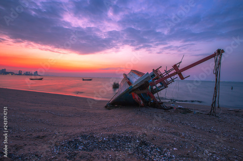 The background of the sea and the evening twilight by the beach, is a natural beauty each day, with fishing boats docked and there is a blur of ocean waves