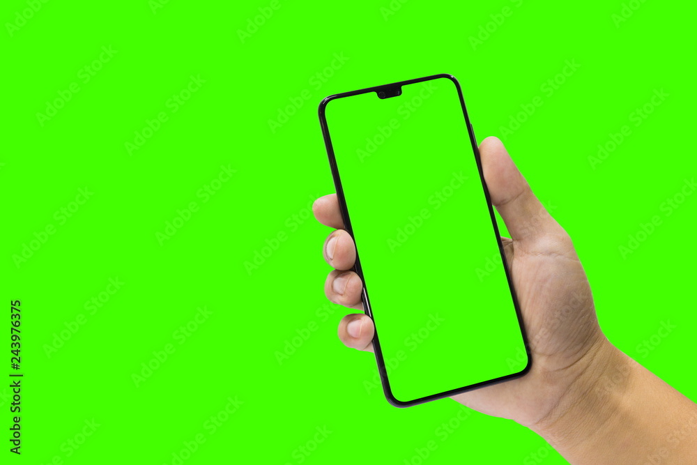 Man holding a black mobile phone and green screen isolated on a ...