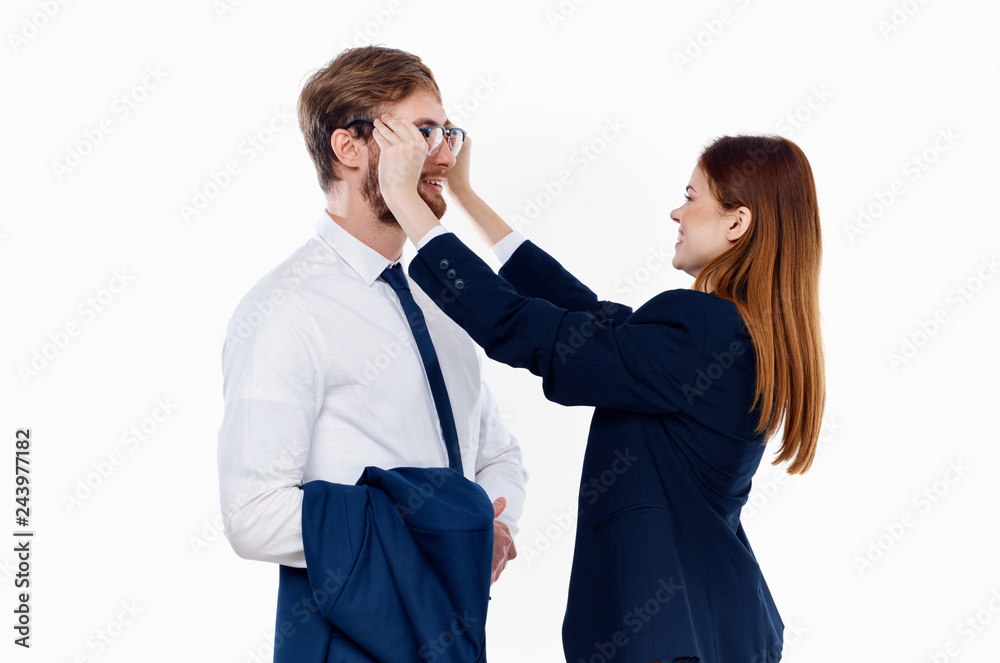 business colleagues woman puts glasses on a man business colleagues woman puts glasses on a man
