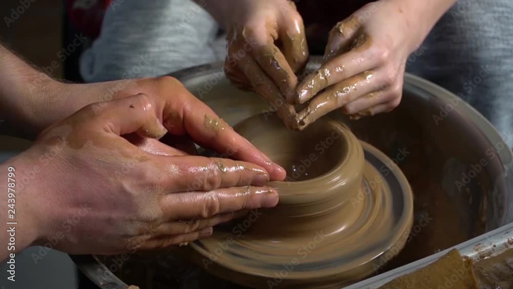 Teaching pottery to children. The teacher gives a master class in modeling Teaching pottery to children. The teacher gives a master class in modeling