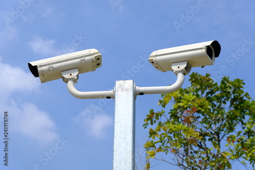 Closed-circuit camera or CCTV on the sky background.