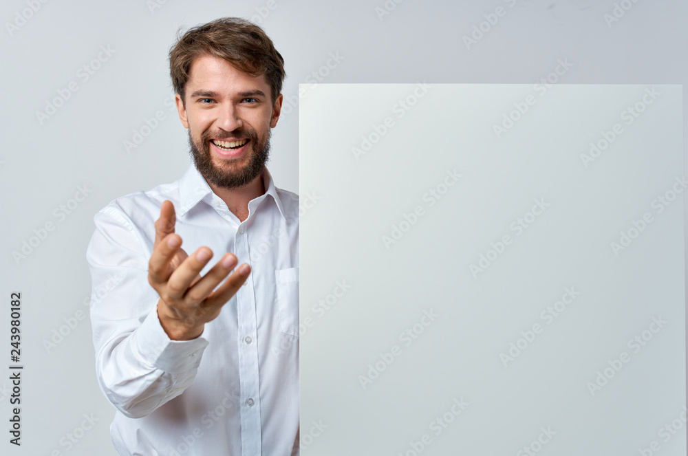 a man in a white shirt holds a poster place free a man in a white shirt holds a poster place free