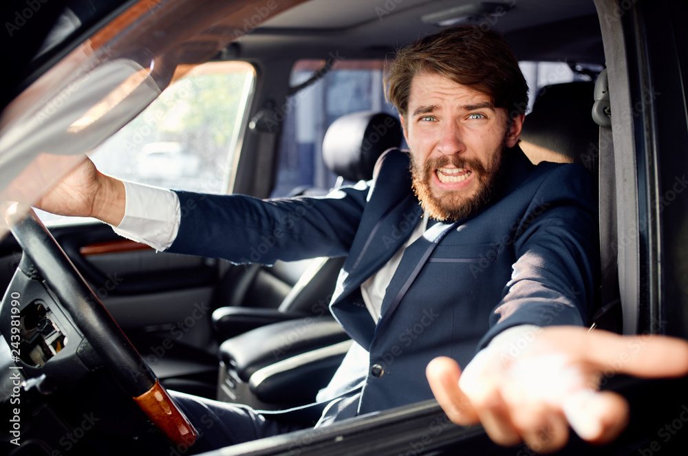 business man with a beard riding a car talking