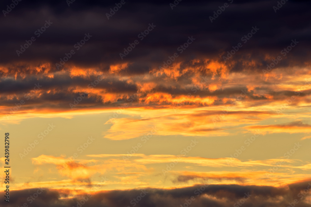Dramatic sunrise golden orange color clouds