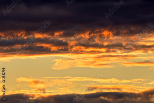 Dramatic sunrise golden orange color clouds