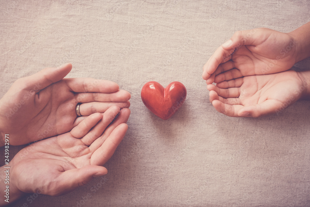 hands and red heart, health insurance, donation and charity, organ donor day, social distancing concept hands and red heart, health insurance, donation and charity, organ donor day, social distancing concept