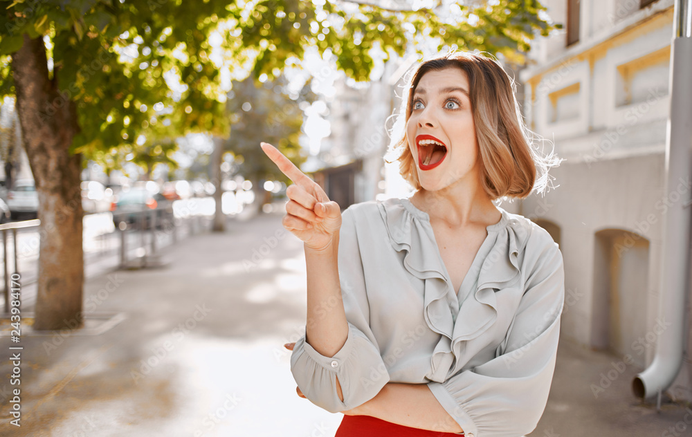 joyful woman points her finger to a free street city joyful woman points her finger to a free street city