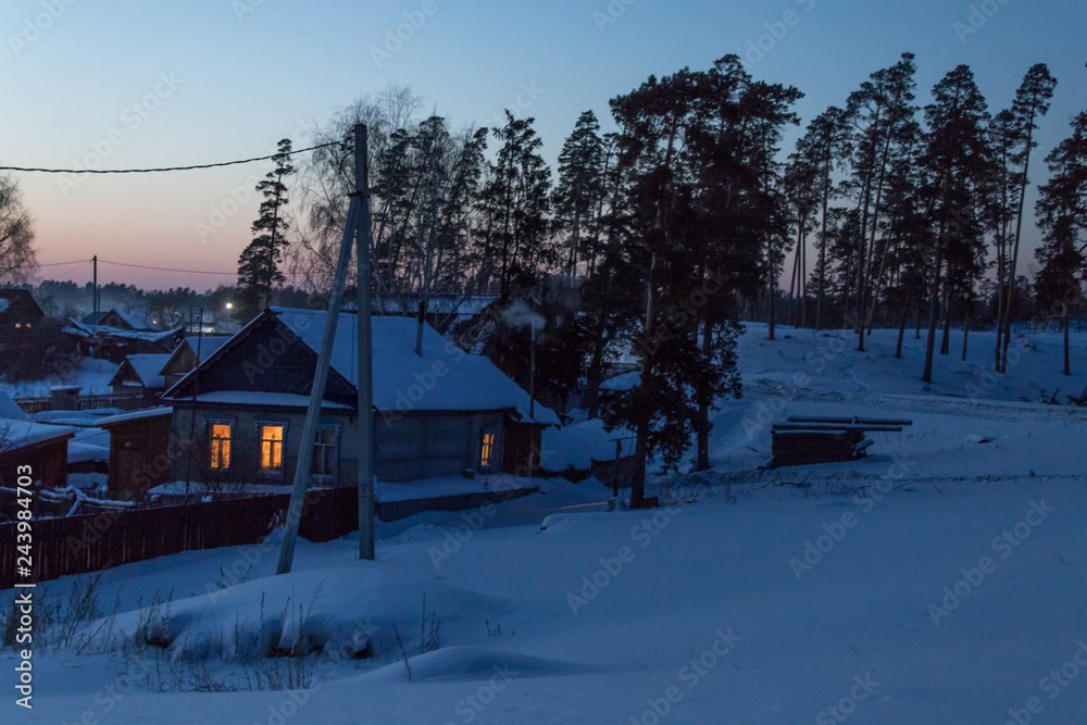 evening village in a pine forest