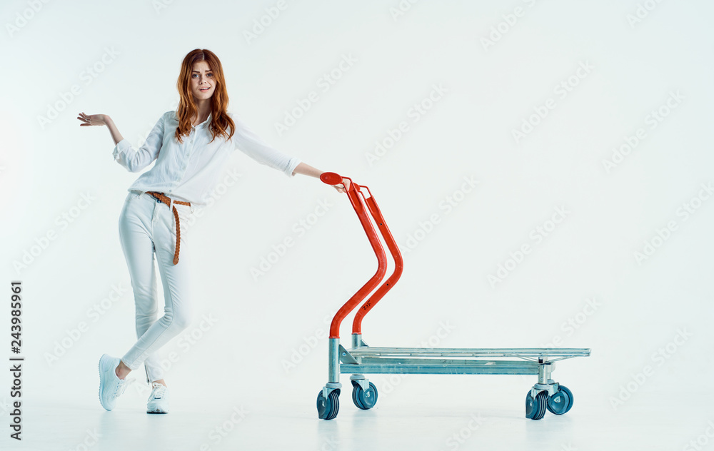 woman stands with a trolley