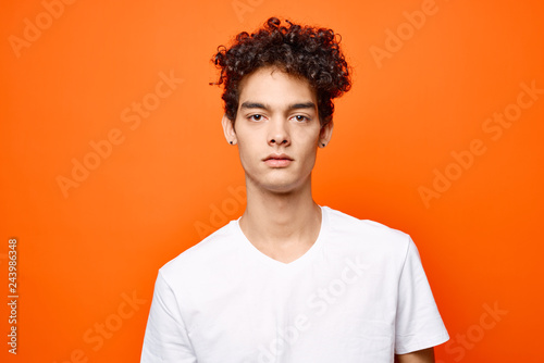 serious africa man on orange background portrait