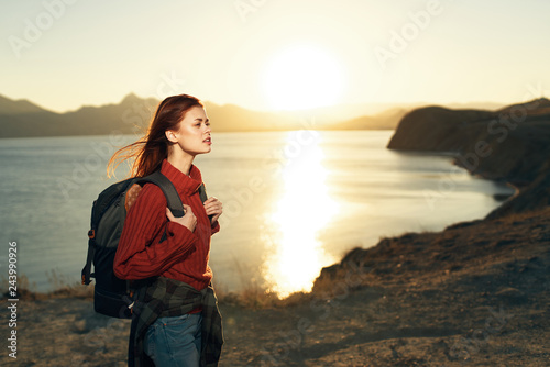 woman with backpack at sea sunset nature autumn