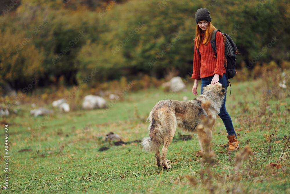 woman traveler with a dog in nature
