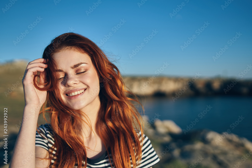 happy woman with closed eyes on the background of the sea
