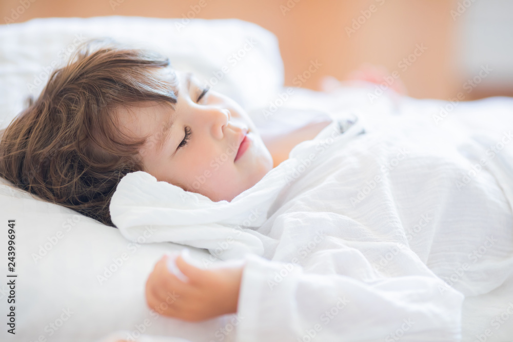 Adorable little girl lying in the bed and sleeping in the early morning Adorable little girl lying in the bed and sleeping in the early morning