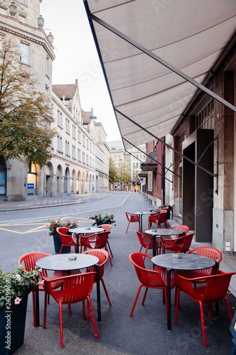 Street cafe with modern red chairs in Zurich Old town Altstadt photo