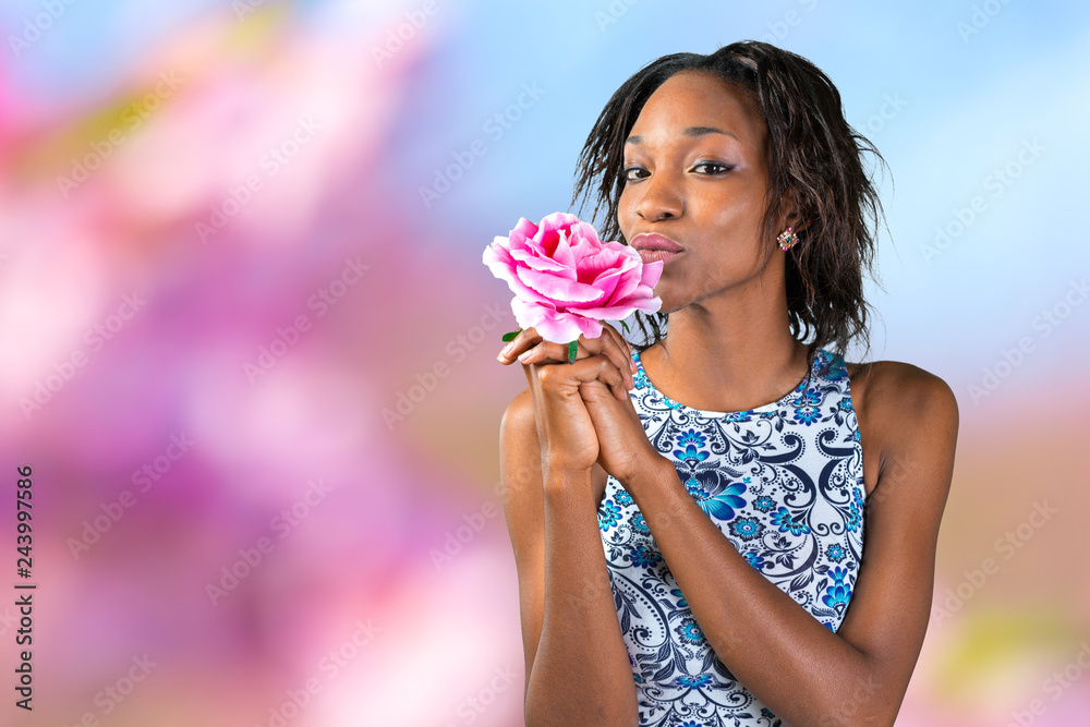 charming beautiful African woman holding flower